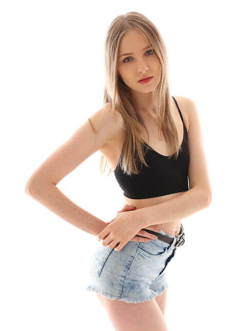 Slender blond teen Nimfa in sexy shorts shows tiny tits and spreads her legs 